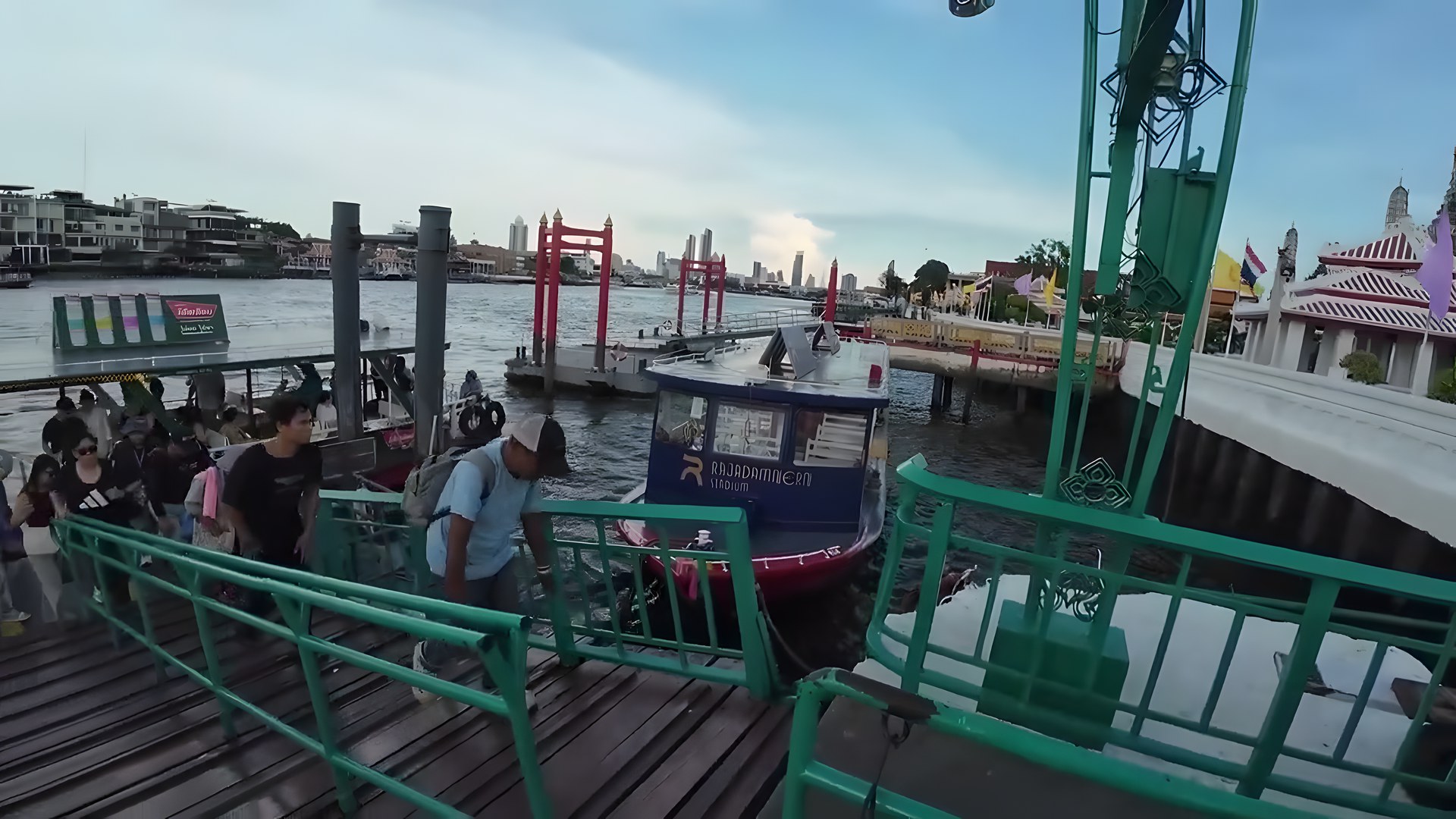 Chao Phraya Nehri üzerindeki feribot iskelesi, tekne ve Bangkok silüeti
